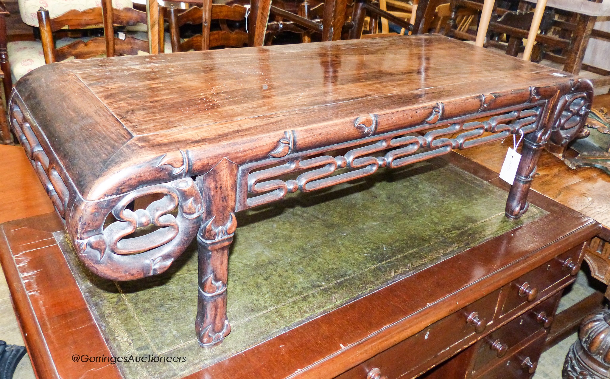 A Chinese carved hardwood low occasional table. W-110, D-44, H-32cm.